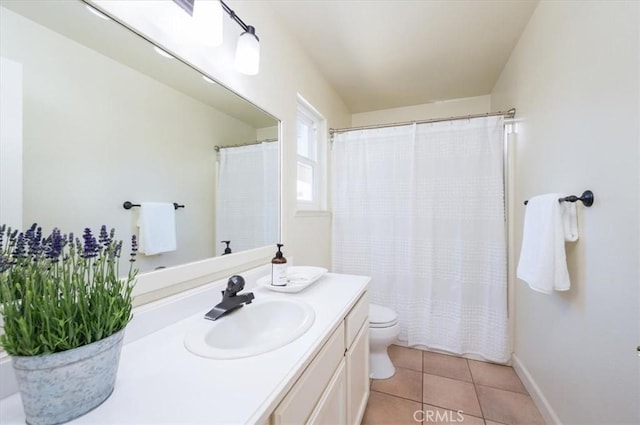 bathroom featuring tile patterned flooring, vanity, and toilet