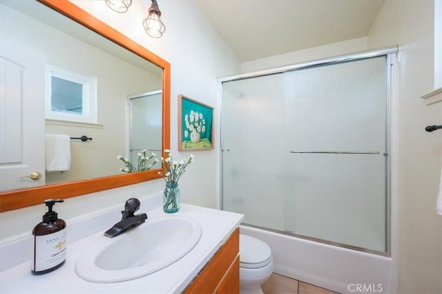 full bathroom with tile patterned flooring, vanity, toilet, and bath / shower combo with glass door