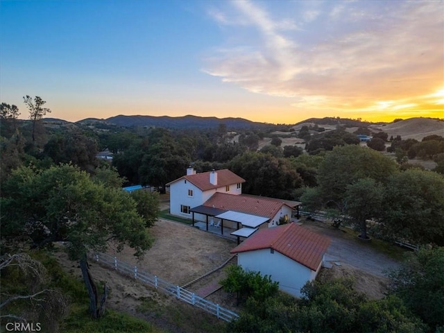 aerial view at dusk featuring a mountain view