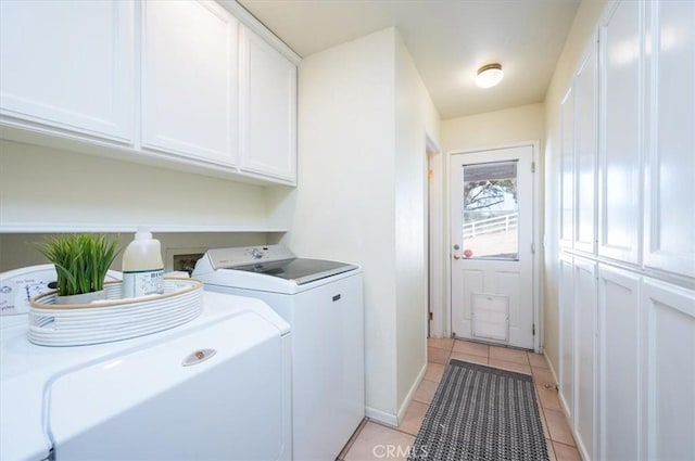 laundry area with cabinets, independent washer and dryer, and light tile patterned floors