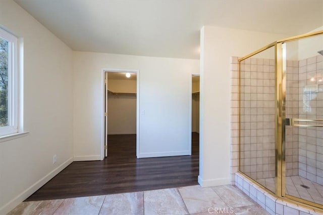 bathroom featuring hardwood / wood-style floors and a shower with shower door