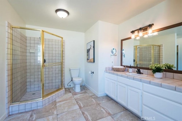 bathroom featuring vanity, a shower with shower door, and toilet