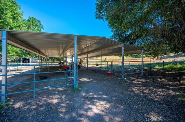 view of horse barn featuring a rural view