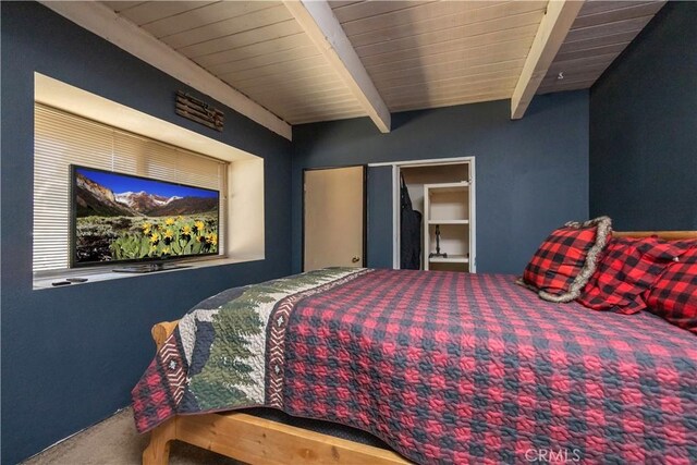 bedroom featuring carpet floors, a closet, beam ceiling, and wooden ceiling