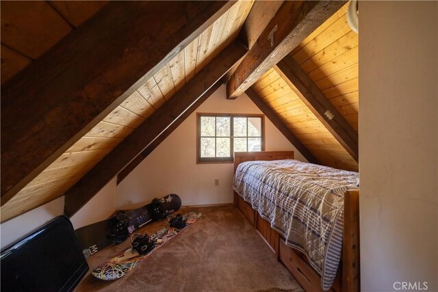 carpeted bedroom featuring lofted ceiling with beams and wooden ceiling