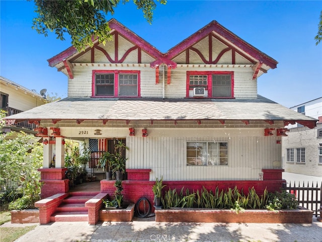 english style home featuring a porch