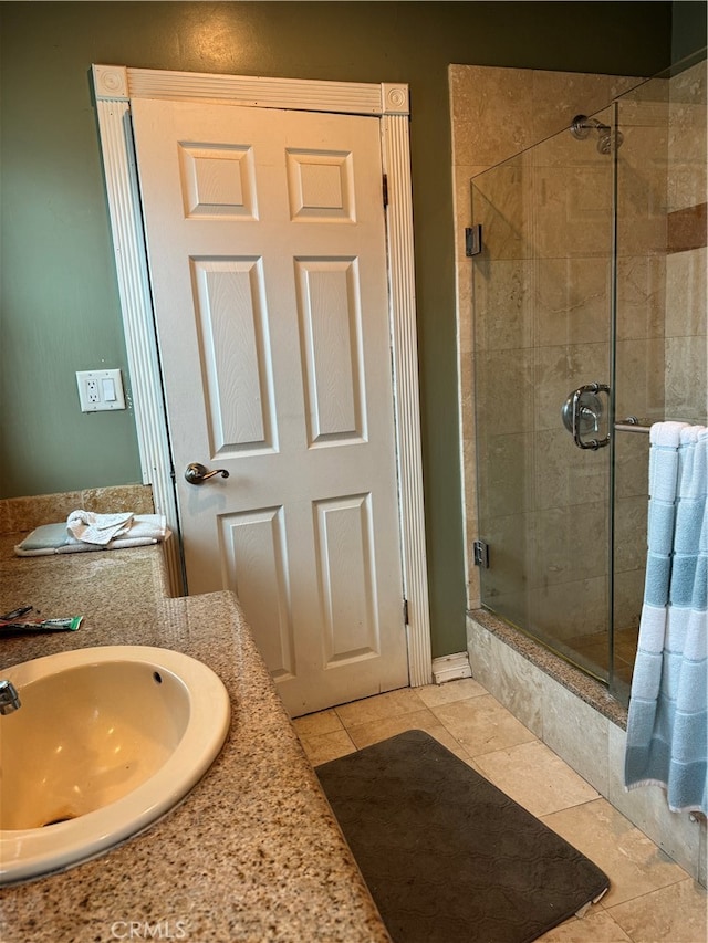 bathroom featuring sink, tile patterned floors, and a shower with shower door