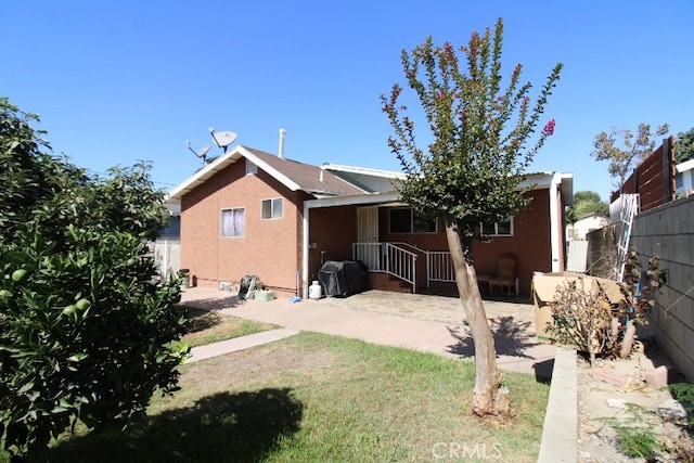 rear view of property featuring a lawn