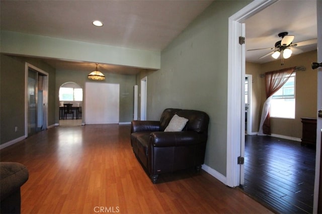 living room with ceiling fan and hardwood / wood-style floors