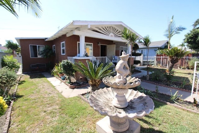 bungalow-style house with a front lawn and a porch