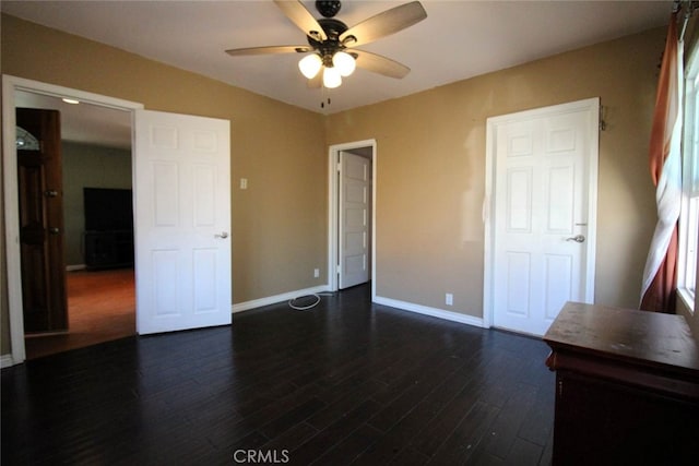 unfurnished bedroom with ceiling fan and dark hardwood / wood-style flooring