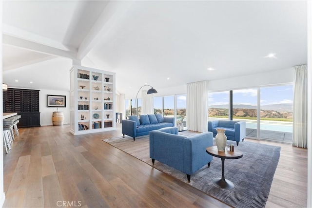 living room featuring lofted ceiling with beams and light hardwood / wood-style floors