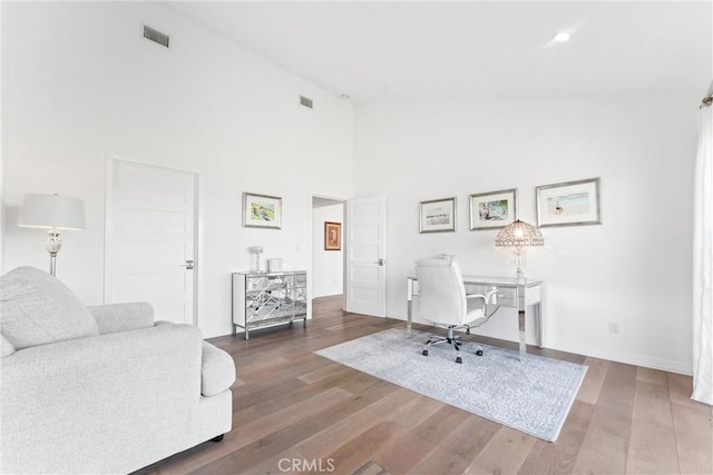 office area featuring dark hardwood / wood-style floors and high vaulted ceiling