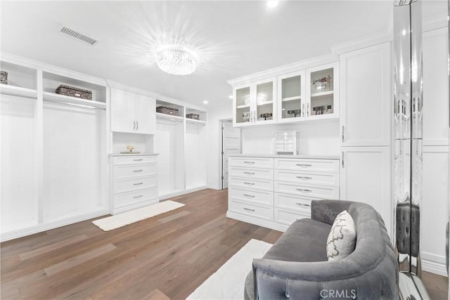 walk in closet featuring dark hardwood / wood-style floors