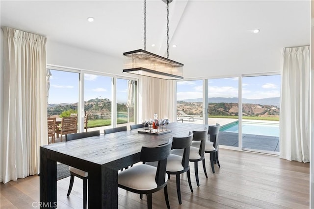 dining room featuring a mountain view and light hardwood / wood-style flooring