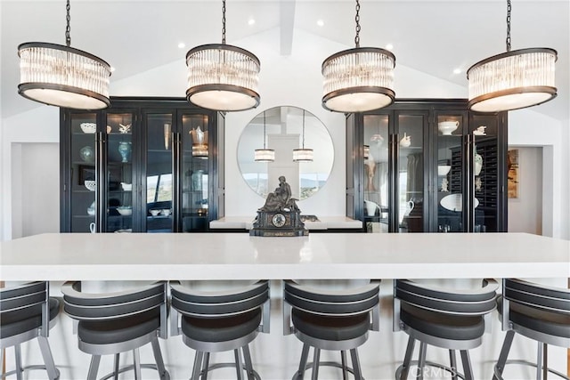 bar with vaulted ceiling and hanging light fixtures