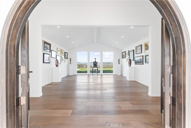 interior space featuring vaulted ceiling with beams and wood-type flooring