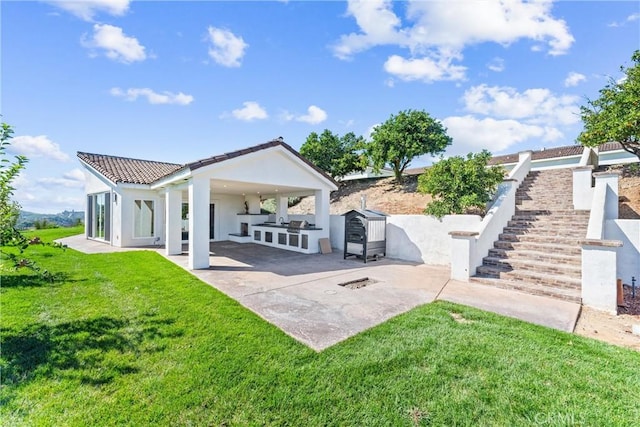 back of property featuring a lawn, area for grilling, and a patio