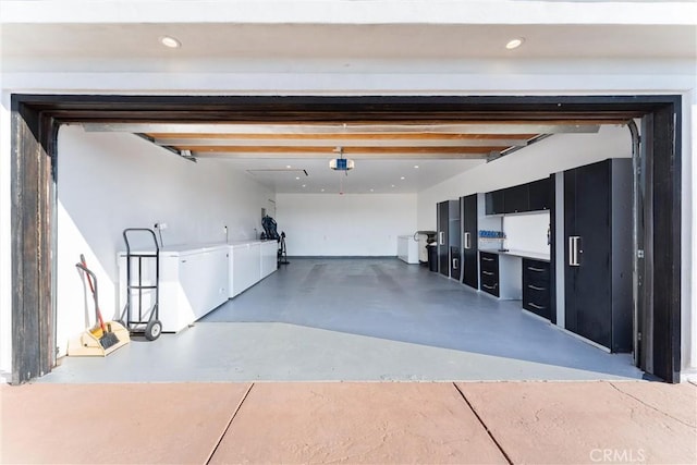 garage featuring washer and dryer and a garage door opener