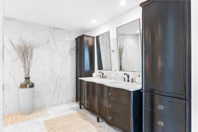 bathroom with vanity and tile walls