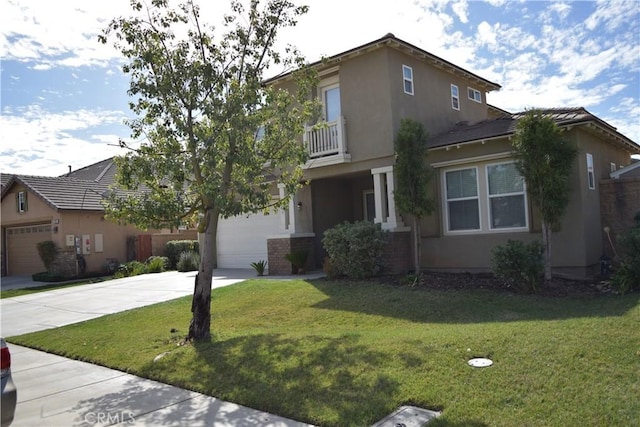 view of front of house featuring a front yard, driveway, a balcony, and stucco siding