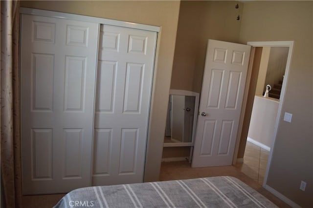 bedroom with a closet and baseboards