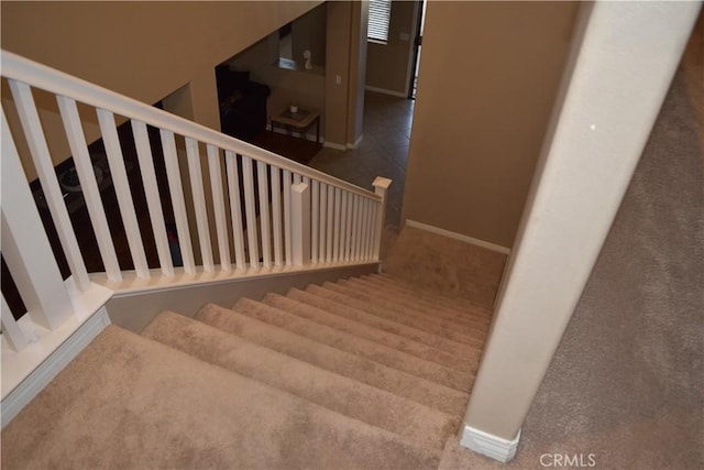 staircase featuring baseboards