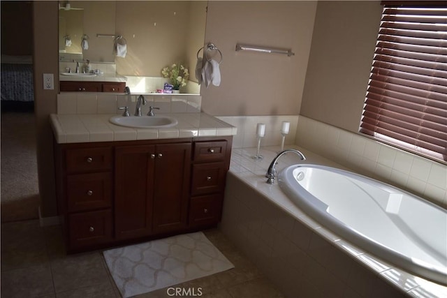 full bath with vanity, a bath, and tile patterned floors