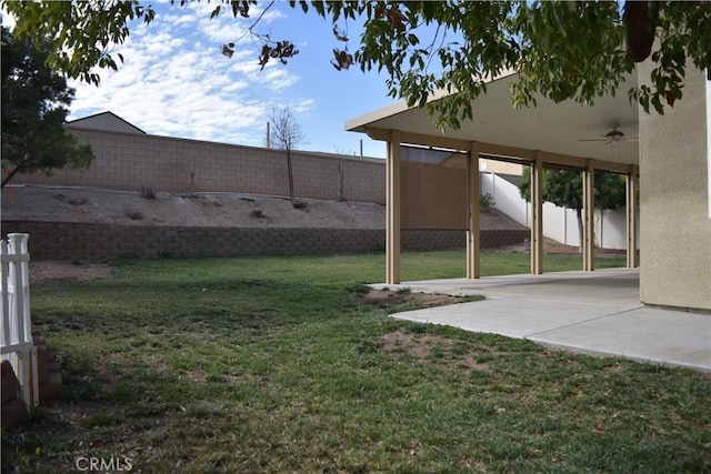 view of yard with ceiling fan, a patio, and a fenced backyard