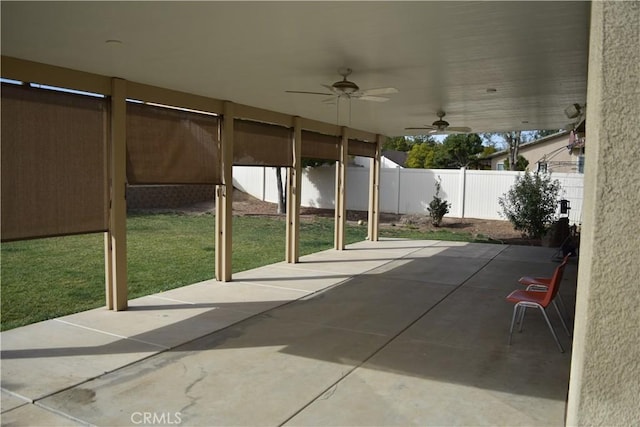 view of patio / terrace with ceiling fan and fence