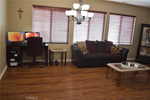 office space featuring a notable chandelier, baseboards, and wood finished floors