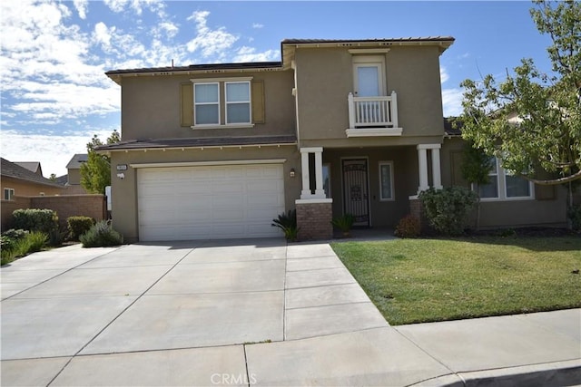 view of front of home with stucco siding, a balcony, a garage, driveway, and a front lawn