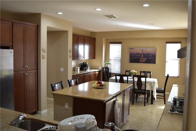 kitchen with light tile patterned floors, recessed lighting, visible vents, appliances with stainless steel finishes, and light stone countertops