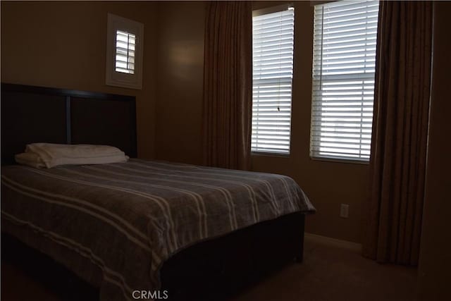 bedroom with carpet floors and baseboards