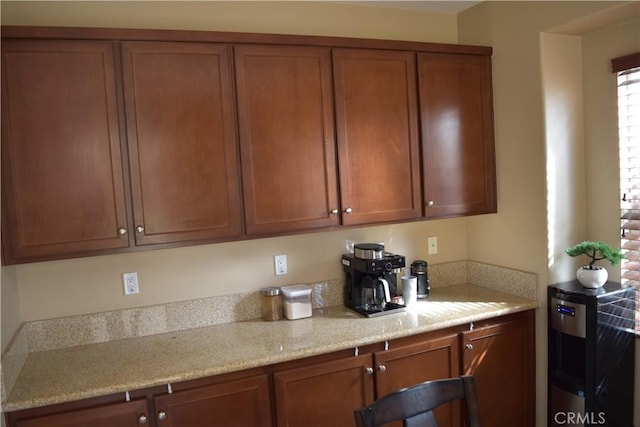 kitchen featuring brown cabinets and light stone countertops