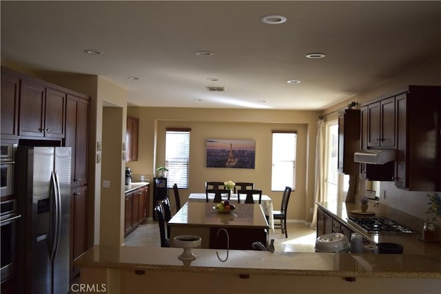 kitchen featuring a center island, recessed lighting, visible vents, appliances with stainless steel finishes, and under cabinet range hood