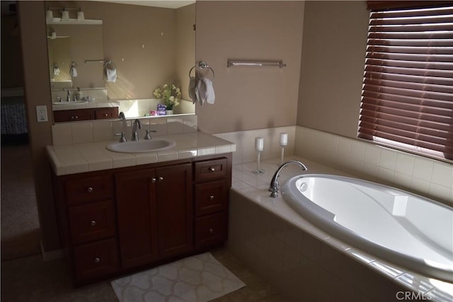 bathroom featuring a garden tub and vanity