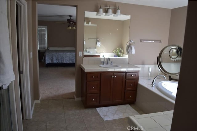 ensuite bathroom featuring ensuite bathroom, ceiling fan, a washtub, vanity, and tile patterned floors