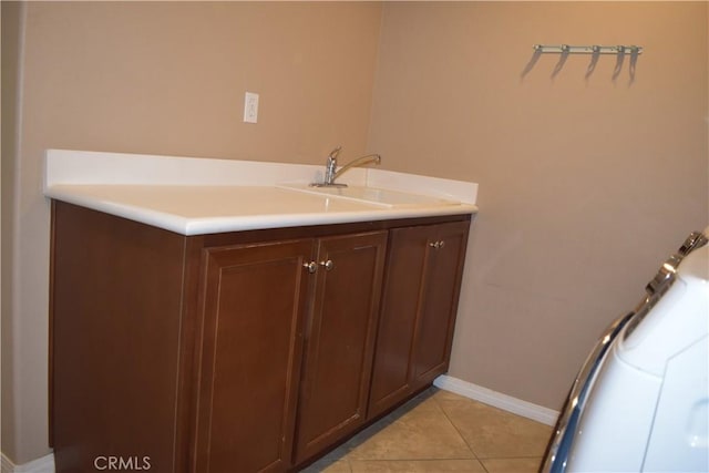 bathroom featuring a sink, baseboards, and tile patterned floors