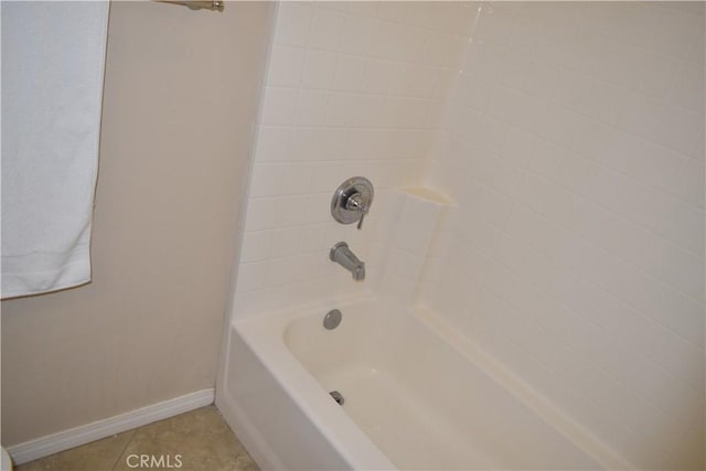 full bathroom with shower / washtub combination, tile patterned flooring, and baseboards