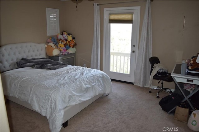 bedroom featuring carpet floors, multiple windows, and baseboards