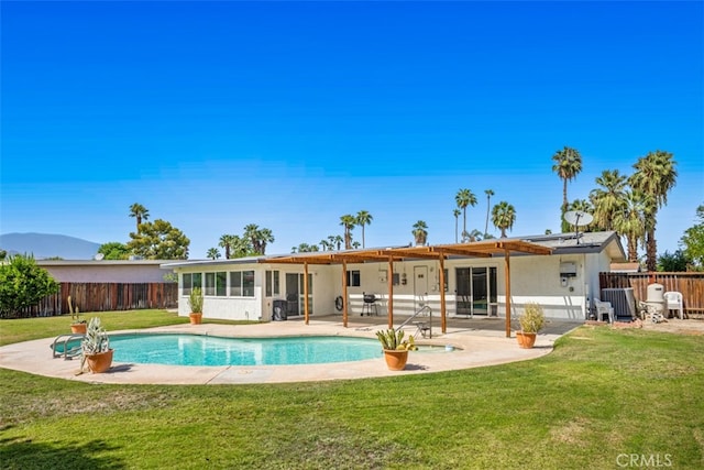 rear view of house featuring a patio area and a yard