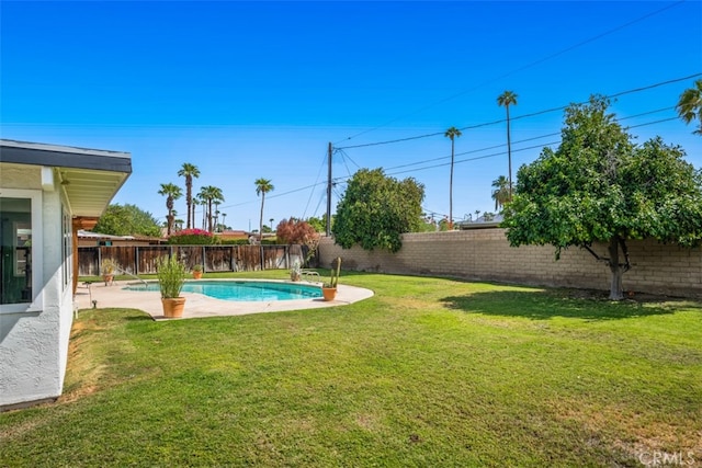 view of yard featuring a fenced in pool and a patio area