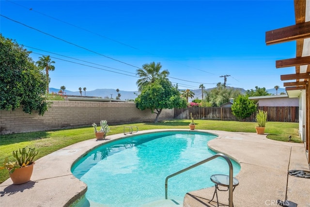 view of swimming pool with a mountain view, a lawn, and a patio