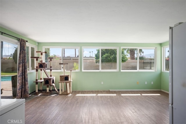 unfurnished sunroom with plenty of natural light