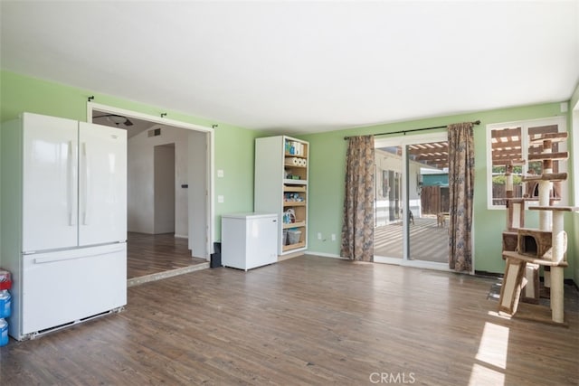 unfurnished living room with dark hardwood / wood-style flooring