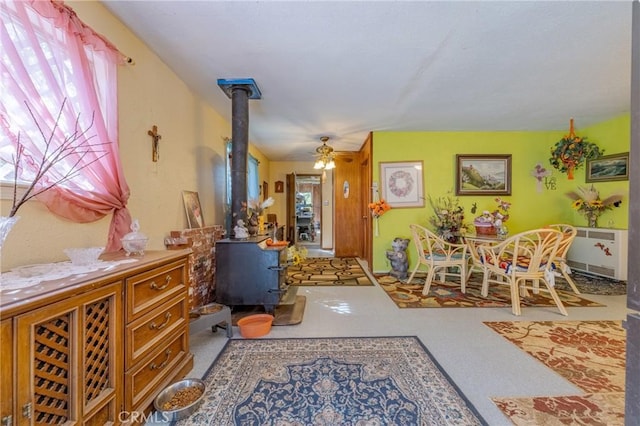 entrance foyer featuring a wood stove and a ceiling fan