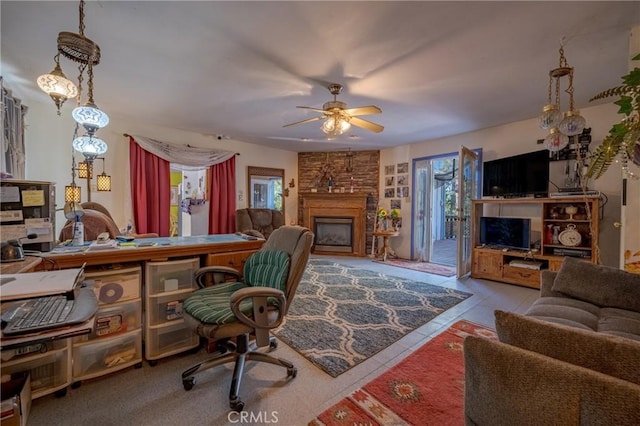 living area featuring ceiling fan and a fireplace