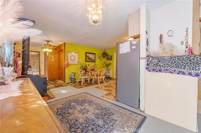 interior space featuring ceiling fan with notable chandelier