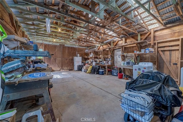 miscellaneous room featuring a workshop area and unfinished concrete flooring